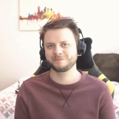 a man wearing a purple shirt has headphones on his ears