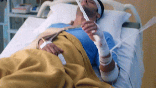 a person with a tube strapped to their neck on a hospital bed