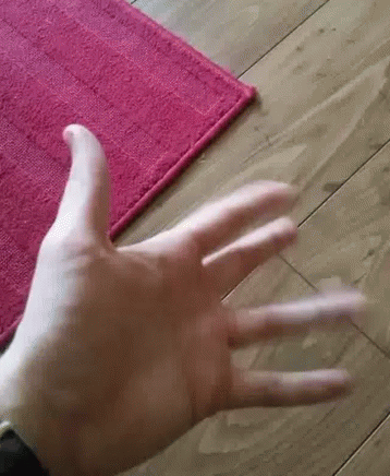 this person's thumb up on a purple rug