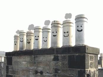 the group of chimneys have faces drawn on them