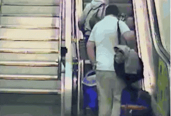 an escalator with people walking up and down it