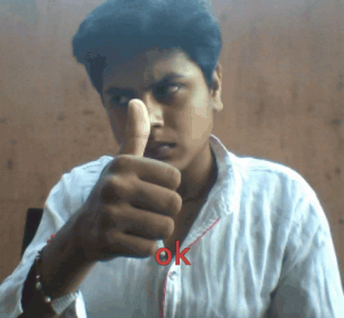 a man in a white shirt pointing his finger at soing