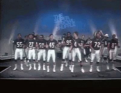 an old tv with football players standing in the middle