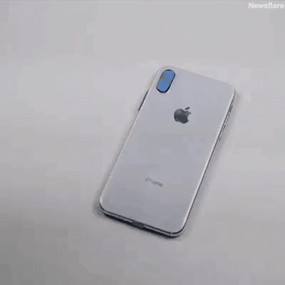 an iphone phone sitting on top of a white table