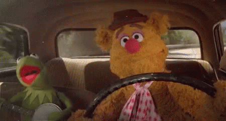 the sesame street characters are driving in the car