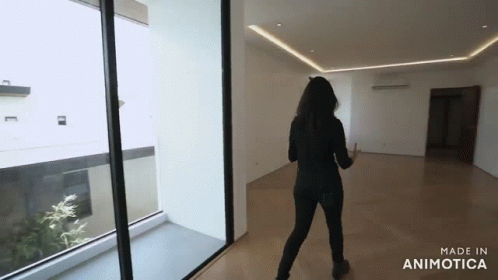 a person in black is walking into a large hallway