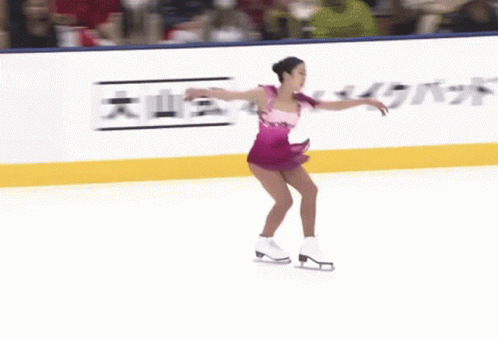 a woman is riding a skateboard down the ice