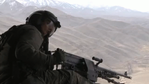 a soldier is looking out over the mountains