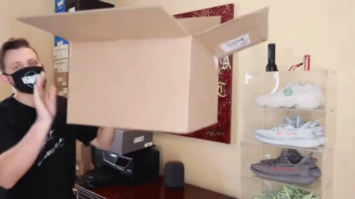 a woman holds the door open to make a cardboard box