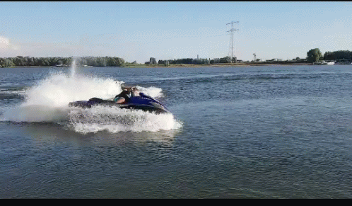 two people riding on a jet skis through the water