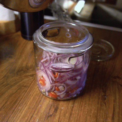 an artistic glass container with swirly paint