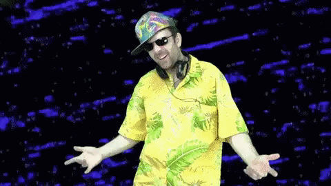 the man is wearing sunglasses and dancing with his hands out