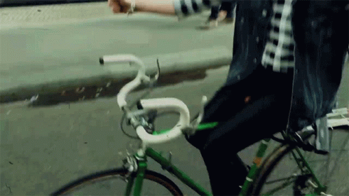 a man with white rings on a green bike