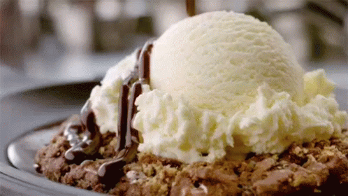 a scoop of ice cream on top of some chocolate