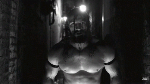 an unknown man with chains in a dark room