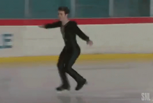 man in black ice skating on the ice