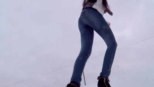 a girl is wearing a backpack and skis while jumping in the air