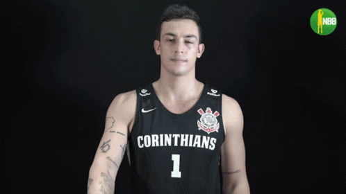 young man with tattoo wearing college uniform