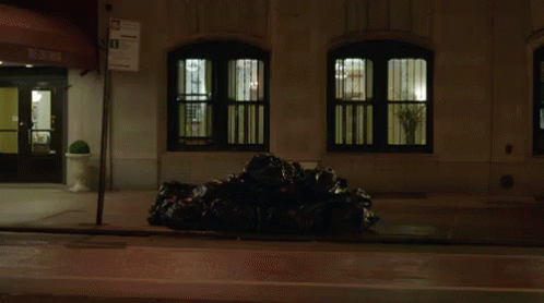 an office building at night with a large pile of garbage