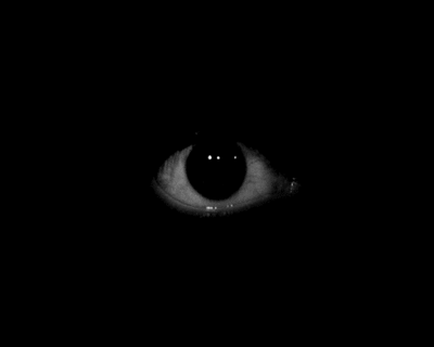 a black po of an eye in the dark
