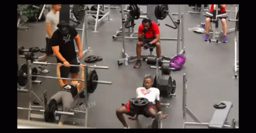 people working out in a gym with weight machines
