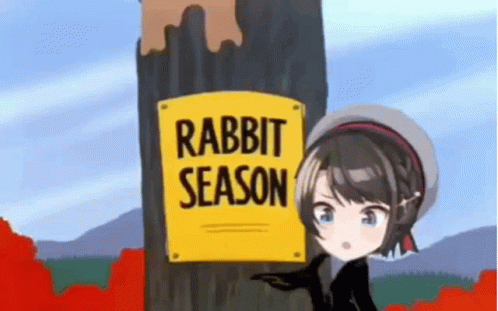 cartoon showing rabbit sitting up against sign reading rabbit season