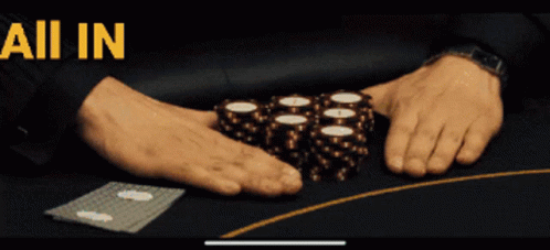 some blue hands holding some dice on a table