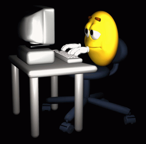 a cartoon blue ball sitting in front of a computer