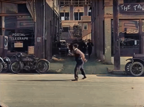 a man skateboards down a street in a town