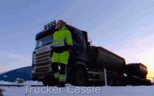 a trucker wearing green is facing forward
