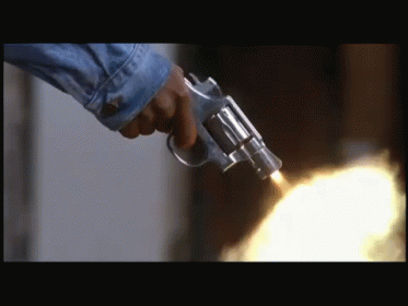 a person wearing blue gloves holds a gun