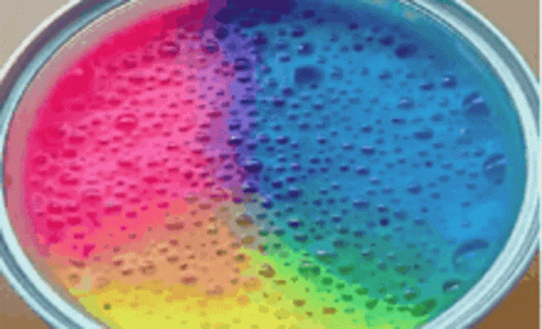 a rainbow colored disc with bubbles floating down