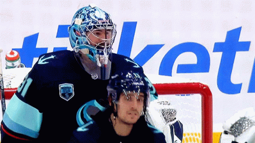 a pograph of a man standing next to a goalie