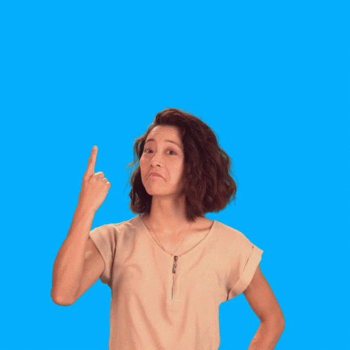a girl pointing in the direction on an orange background