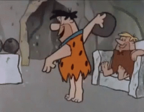 a caveman throws soing up in the air with his head