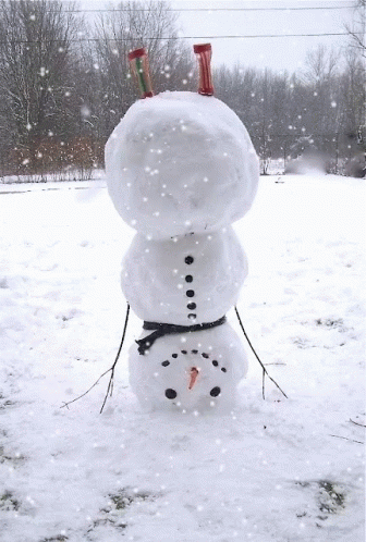 a snowman with a purple tube sitting on it's head