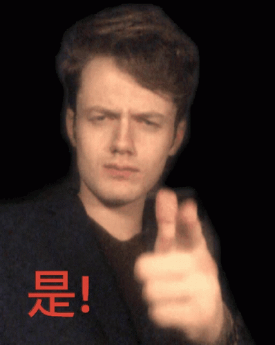 a man making the finger gesture sign with a blurry po in the background