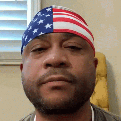 an image of a man wearing an american flag head band