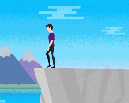 the man is standing on top of a cliff
