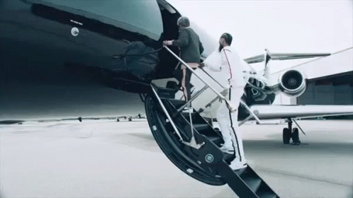 a person climbing a stair case in front of a plane