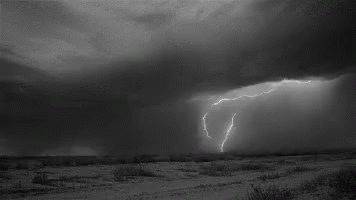 a po with lightning in the distance with black clouds and dirt