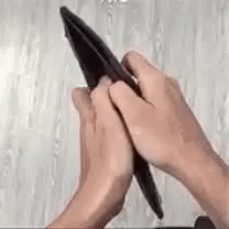 two hands holding a pen while touching each other