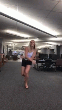 woman dressed in lingerie walking around in the middle of an office