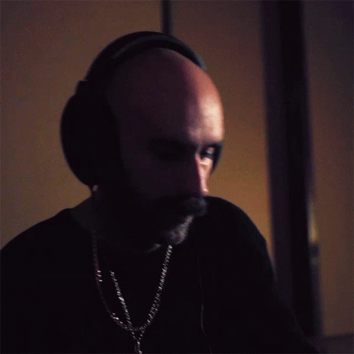 a man with headphones on, staring to the right