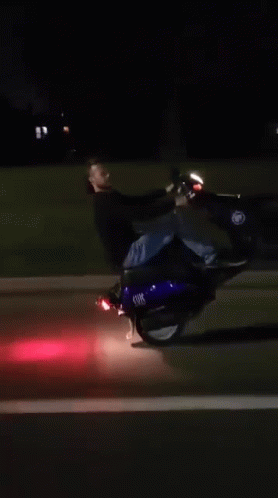 man is falling backwards on his motorcycle