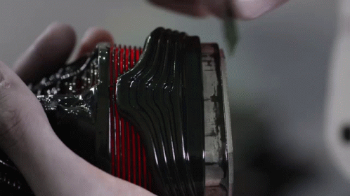 someone holding a black comb with many other items in it