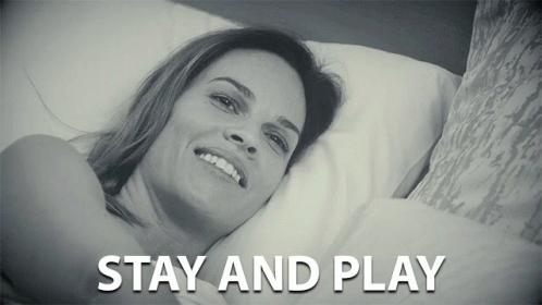 a young woman lying on top of a pillow with the words stay and play above it