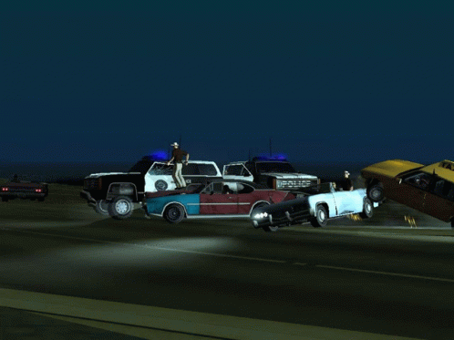 a group of wrecked cars on highway at night
