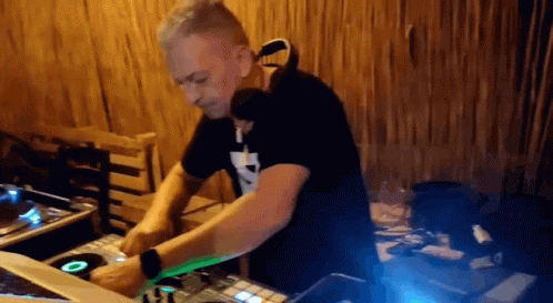 a dj mixing music at the back of a stage