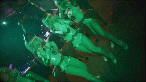 two dancers in green bodysuits are dancing